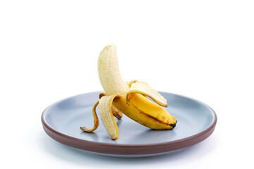 Yellow ripe bananas placed on a plate Ripe bananas with black spots on the peel. Banana overripe rotten, isolated on white background