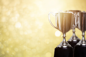 Wall Mural - golden trophy award with bokeh soft gold background. copy space for text. winner or 1st place gold t