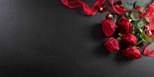 Love And Valentine's Day Concept Made From Red Rose And Gift Box On Black Wooden Background. Top View With Copy Space, Flat Lay.