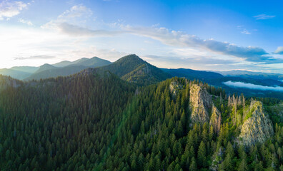 Peak of Rhodope mountain with forests against background of clouds. Panorama, top view