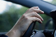 © Robert - Close up of right hand on steering wheel. Men driving the car.