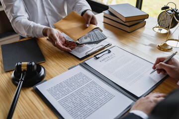 Wall Mural - business people shaking hands and Give an under-the-table bribe to an attorney to help a lawyer win a court case. Bribery and Kickback Ideas Fraud and Fraud