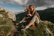 Woman Sitting with Vizsla Dog at Mountain Peak
