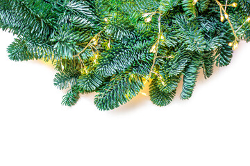 Wall Mural - christmas tree border isolated on white background. fir tree branches with sparkling golden lights g