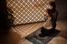 Portrait Of A Muslim Woman Praying At Home