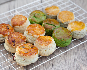 Wall Mural - Four flavours of homemade scone with raspberry jam and clotted cream (butter, cranberry, matcha and Earl Grey)