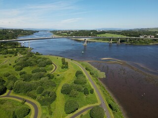 Wall Mural - Aerial view of the Foyle Bridge in Londonderry, Northern Ireland with a calm river and lush greenery