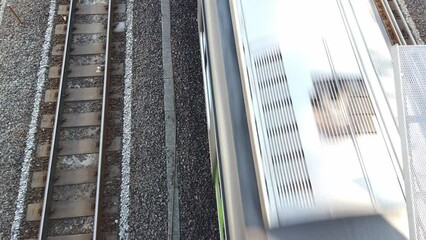 Canvas Print - top down view over to the japan track railway with train running moving passing , japan modern public transportation