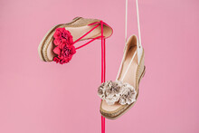 Different Stylish Sandals Against Pink Background