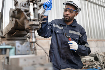 Portrait African American engineer work with machine at lathe factory	