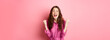 © Mix and Match Studio - Beautiful smiling woman scream with happy and excited face, saying yes, making fist pump, winning and feeling like champion, triumphing, standing over pink background
