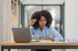 © David - Portrait of tired young business african american woman work with documents tax laptop computer in office. Sad, unhappy, Worried, Depression, or employee life stress concept