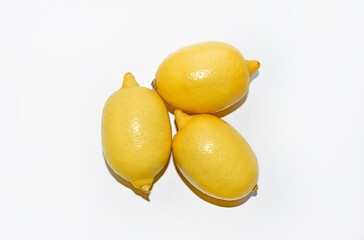 Wall Mural - Yellow ripe lemon on a white background. Juicy lemons close-up. Isolate of the fruit of a yellow lemon.