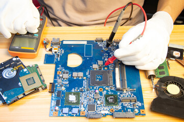 Fototapete - Technician repairing computer motherboard, notebook motherboard