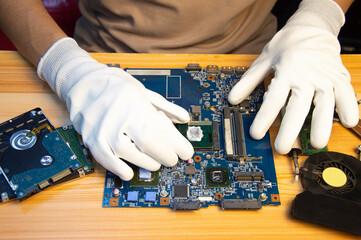 Fototapete - Technician repairing computer motherboard, notebook motherboard