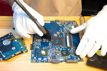 Fototapete - Technician repairing computer motherboard, notebook motherboard