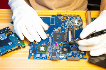 Fototapete - Technician repairing computer motherboard, notebook motherboard