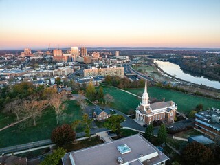 Canvas Print - Drone view of a city skyline with buildings near the river in New Brunswick, Rutgers, Hub City, USA