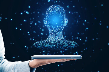 Aufkleber - Close up of hand holding tablet with glowing digital blue head outline on dark background. Machine learning, AI and technology concept.