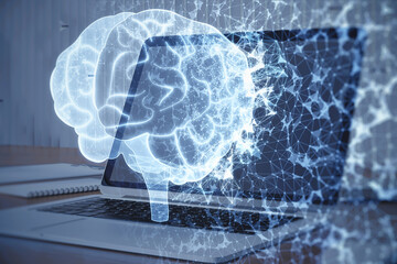Poster - Close up of table with computer and abstract glowing polygonal human brain hologram on blurry background. Digital intelligence, ai and future concept. Double exposure.