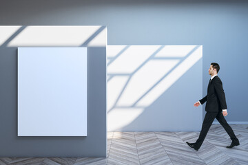 Aufkleber - Side view of blurry business man walking in spacious gallery interior with empty poster and sunlight shadow on concrete wall. Mock up.