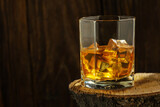 Fototapeta Tulipany - Whiskey with Ice on a Wooden Table