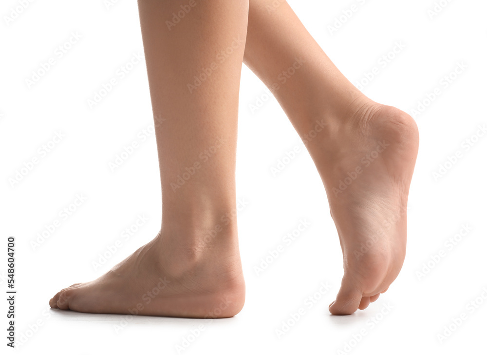 Female bare feet on white background