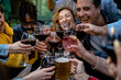 © Vittorio Gravino - Group of multietnic friends toasting at bar restaurant - Leisure  concept with young people having fun together at dusk.