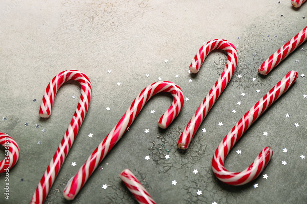 Sweet candy canes on grunge background