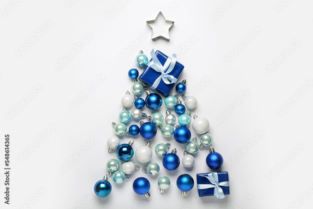 Christmas tree made of beautiful balls and gift on light background