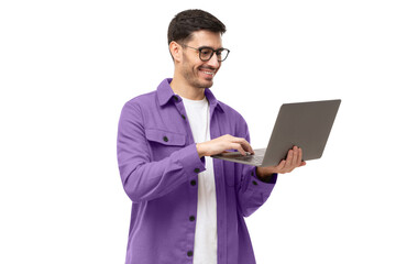 Wall Mural - Young man wearing casual purple shirt, standing with opened laptop in hands, surfing online