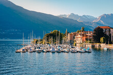Pier On Lake Como With Boats Moored At Sunset