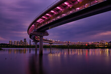 Illuminated Bridge Over River Against Sky At Night