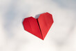 © Tetra Images - Red origami heart on white background