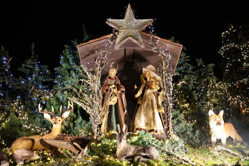 Christmas nativity scene Christmas  market stall decoration with fir trees deer and fox in the forest