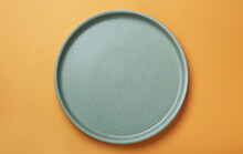 Empty Ceramic Plate On Pale Orange Background, Top View