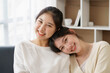 © amnaj - Happy LGBTQ Asian Lesbian Couple Two Asian girls show their love by cuddling and having romance together at home. Positive emotions and LGBT lesbian moments.