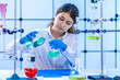 young adult female scientist conducts a chemical experiment in a hydrocarbon synthesis laboratory