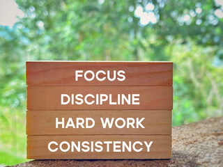 Wall Mural - Focus discipline hard work consistency text on wooden blocks background. Inspirational and Motivational Concept.