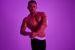 © SHOTPRIME STUDIO - Man athletic body bodybuilder in briefs with nude torso abs full-length in the background fitness classes, purple colored light. Advertising, sports, active lifestyle, competition, challenge concept.