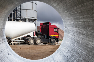 Wall Mural - Machine for transporting cement in a concrete factory. Close-up. Supply of dry building materials for production.