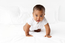 Baby Boy Crawling On White Bed