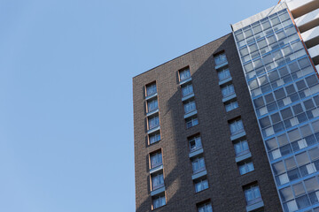 A new high-rise building against the blue sky. 