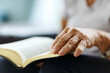 © Алина Битта - Closeup of senior woman's hands on bible, folded in prayer