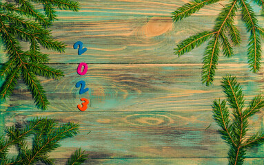 Wall Mural - Christmas wooden background with fir branches and a place to copy.