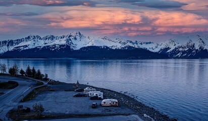 Poster - Camper vans parked near a lake against snowy mountains and scenic sunset in Seward, Alaska