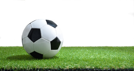 Wall Mural - Soccer ball on synthetic grass and white isolated background