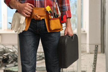 Poster - Professional builder with tool belt indoors, closeup