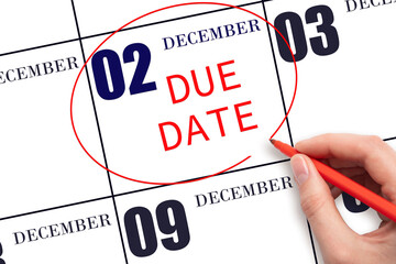 Hand writing text DUE DATE on calendar date December 2 and circling it. Payment due date