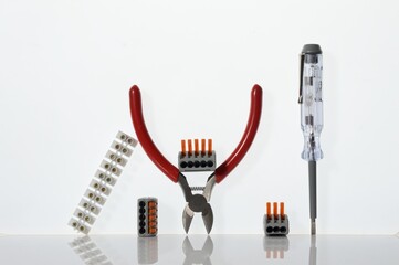 Different tools for electronics repair laid out on a white background